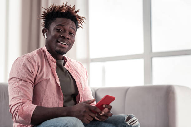 istock Cheerful young male testing his new earphones 1136192677