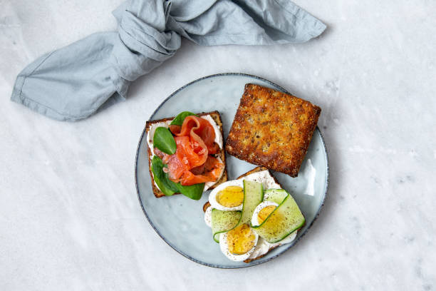istock Smorrebrod - danish open sandwich with fish, vegetables, cheese on marble background. Top view with copy space 1136194386