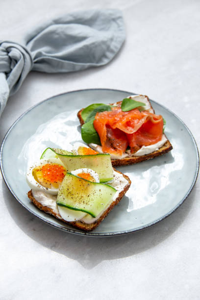 istock Smorrebrod - danish open sandwich with fish, vegetables, cheese on marble background. Top view with copy space 1136194598
