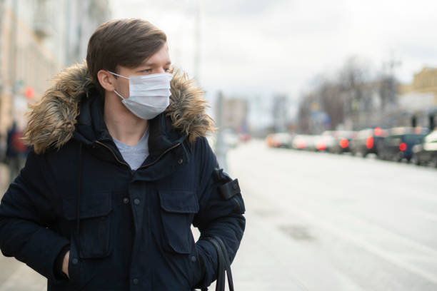 close up man wear cloth mask in the city, polluted air - illness mask pollution car imagens e fotografias de stock