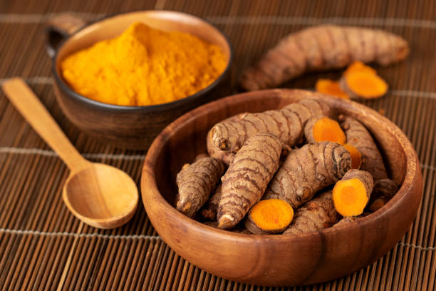 istock Turmeric roots and powder in close up. Selective focus 1136198153