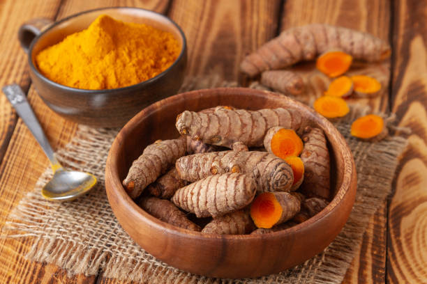 istock Turmeric roots and powder rustic still life 1136198243