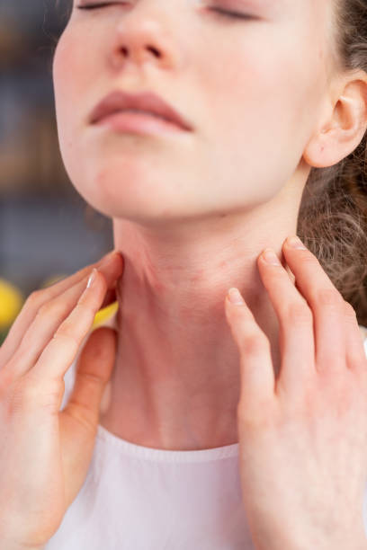 istock Disturb young woman closing her eyes and scratching neck 1136200324