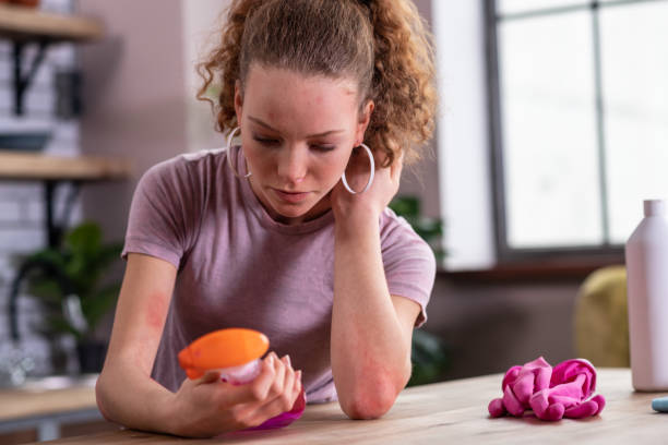 istock Distressed good-looking girl with ponytail being covered with red spots 1136200409