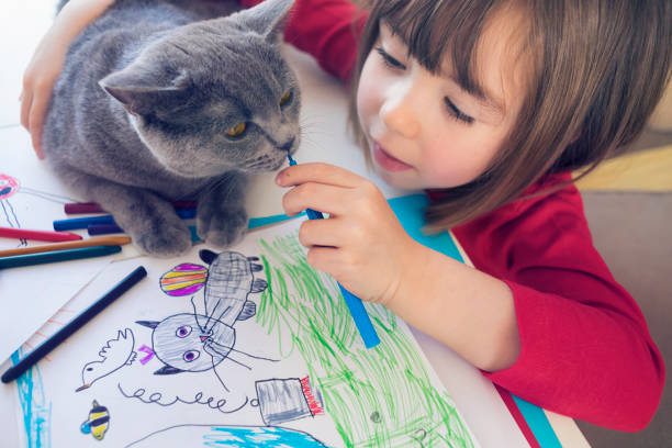 Child with kitty drawing at home