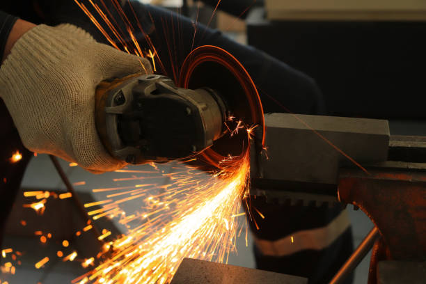 istock a gloved worker with a grinder cuts a carbide plate and this causes a lot of sparks 1136200631