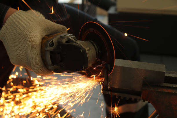 istock a gloved worker with a grinder cuts a carbide plate and this causes a lot of sparks 1136200655