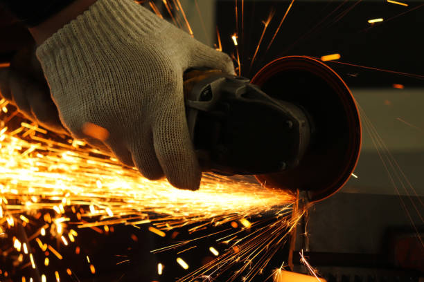 istock a gloved worker with a grinder cuts a carbide plate and this causes a lot of sparks 1136200662