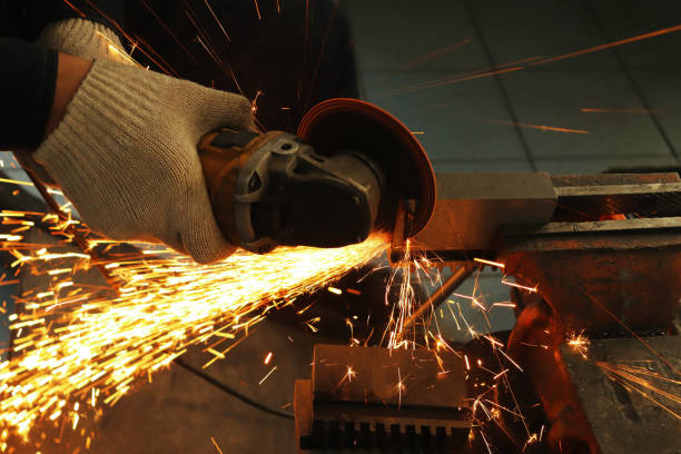 istock a gloved worker with a grinder cuts a carbide plate and this causes a lot of sparks 1136200676