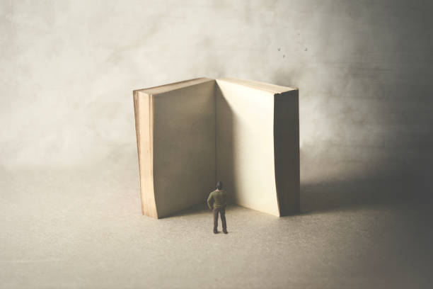 istock little man reading a big empty book, surreal concept 1136202444