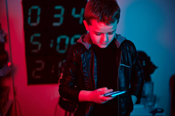 istock Boy is alone at night and type on his smart phone while looking at the screen 1136203035