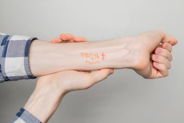 istock pain or ache text word on persons hand concept, creative idea b 1136203243