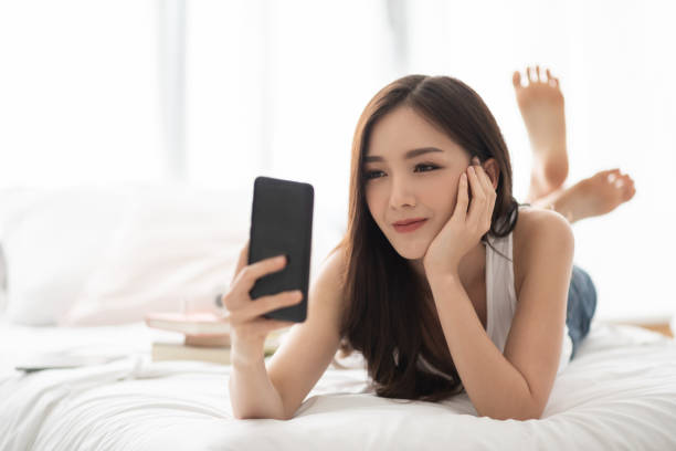 istock Happy Asian Beautiful female using cell phone. 1136203454