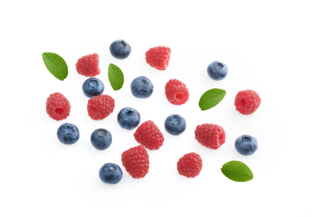 istock Raspberries and blueberries white background top view 1136205342