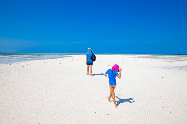 istock Father and Daughter Discovering the Beach during Low tide 1136208344