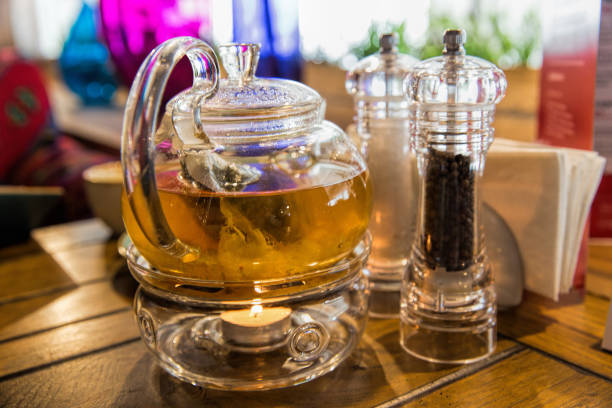 istock Chinese teapot with tea, on a burning support from glass 1136208517