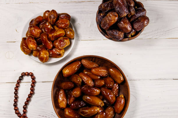 istock Dates fruit and prayer beads on white wooden table. Top view 1136210436