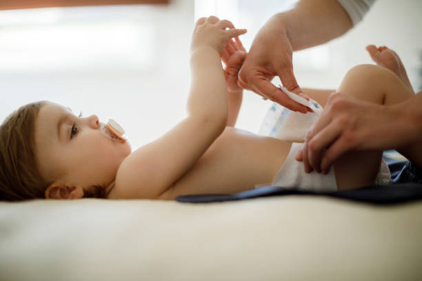 istock Baby girl in bedroom getting diaper changed 1136214761