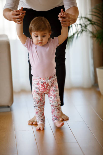 istock Mother teaching her daughter to walk 1136214836