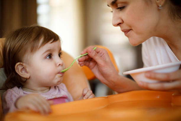 istock Mother feeding her baby 1136215465