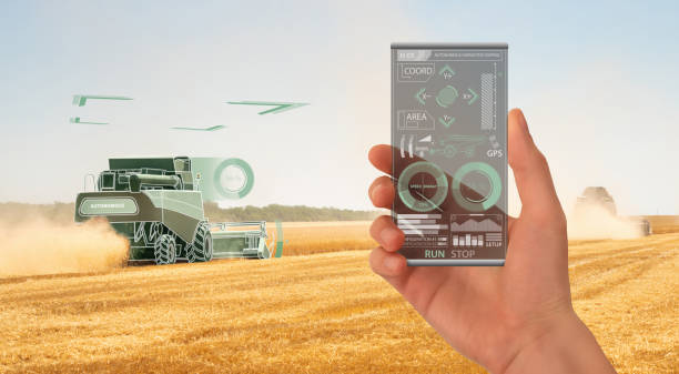 istock Farmer uses a futuristic transparent smartphone to control autonomous harvester 1136215555