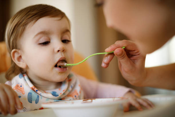 istock Mother feeding her baby 1136215590