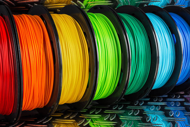 istock colorful bright  row of spool 3d printer filament black metal background 1136216043