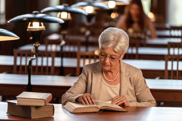 istock Senior Female Professor In Old Library 1136217336