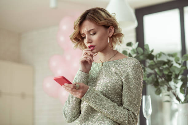 Woman feeling stressed reading message from her man