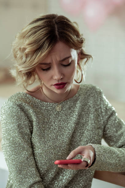 istock Curly blonde-haired woman typing message for her husband 1136220946