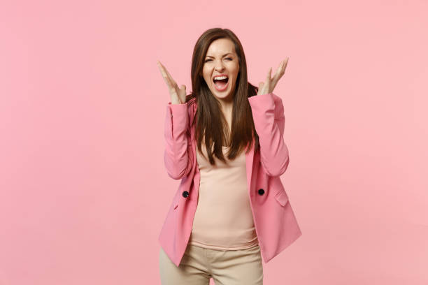 istock Portrait of crazy screaming expression young woman in jacket standing spreading hands isolated on pastel pink wall background in studio. People sincere emotions, lifestyle concept. Mock up copy space. 1136221221