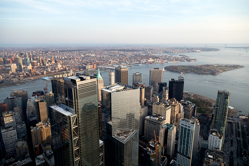Lower Manhattan, New York City, financial district skyline with crowd of skyscrapers, Governors Island and Brooklyn in the background, aerial view.