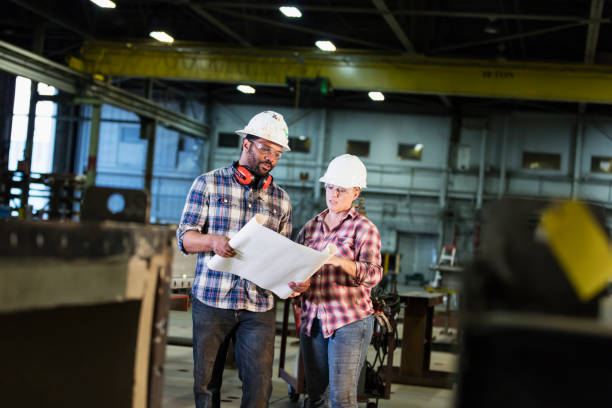 istock Woman working in factory with man 1136224861
