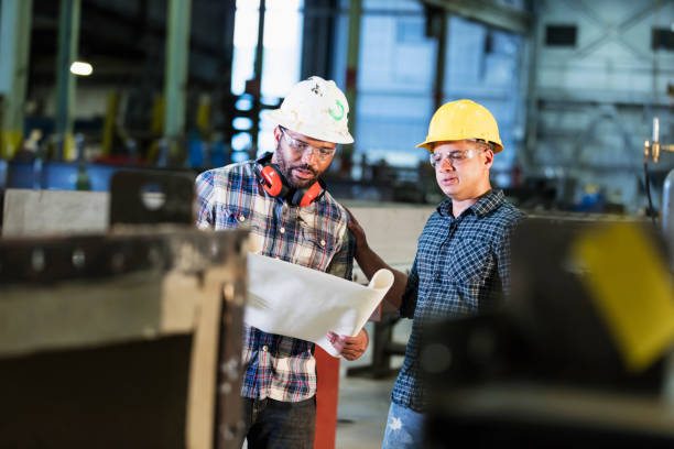 istock Multi-ethnic workers talking in metal fabrication plant 1136225071