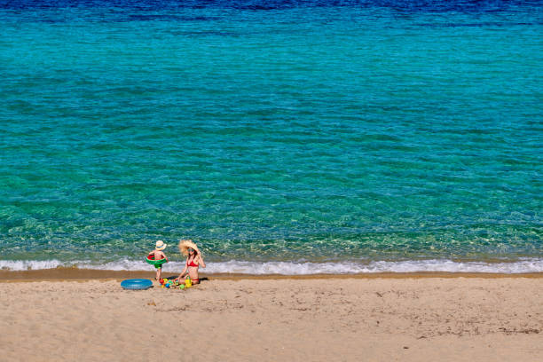 istock Toddler boy on beach with mother 1136225254