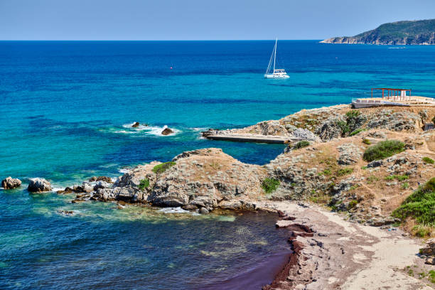 istock Rocky coastline landscape with yacht 1136229165
