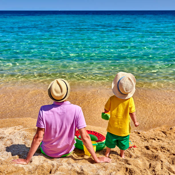 istock Toddler boy on beach with father 1136229218