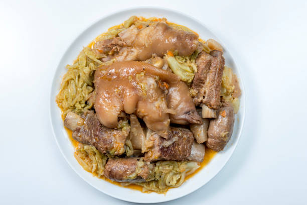 Top view Plate with pork meat and savoy cabbage on white background