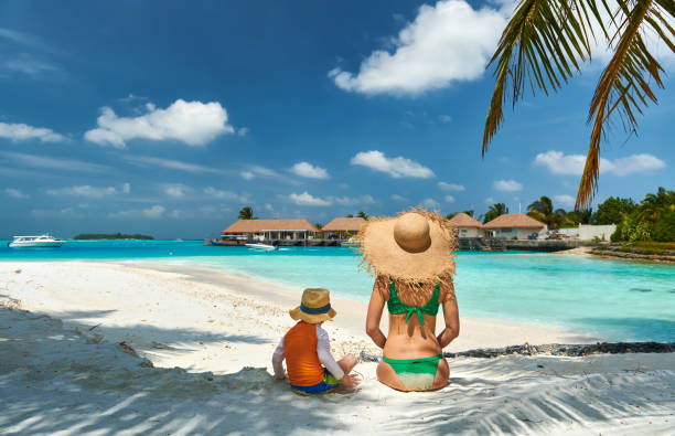 istock Toddler boy on beach with mother 1136231340