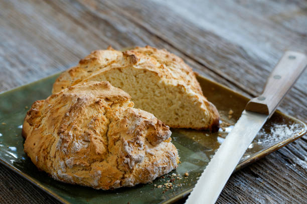 Irish soda bread with whole wheat flour on platter on a rustic table top