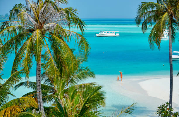 Toddler boy on beach with mother Three year old toddler boy on beach with mother. Summer family vacation at Maldives. sandbar stock pictures, royalty-free photos & images