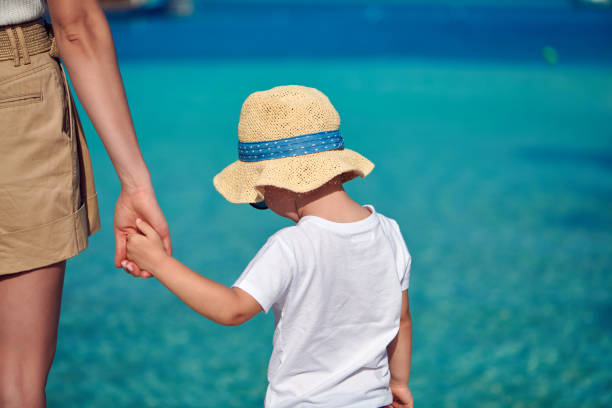 istock Toddler boy on beach with mother 1136232693