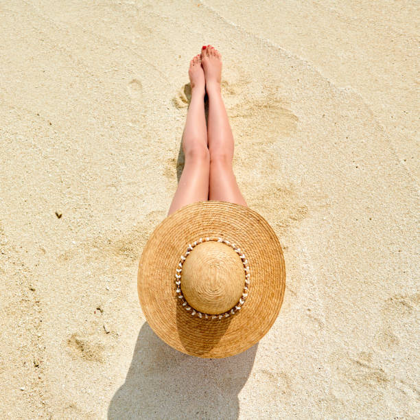 istock Woman sitting on beach view from above 1136232747