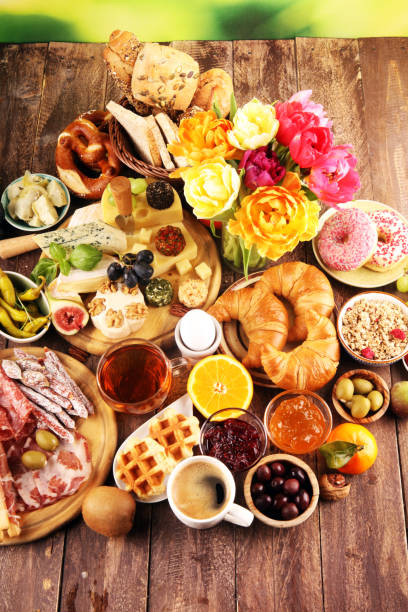 istock breakfast on table with bread buns, croissants, coffe and eggs 1136233623