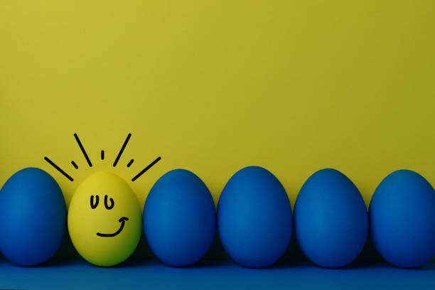 blue and yellow eggs on blue and yellow background - funnyface imagens e fotografias de stock