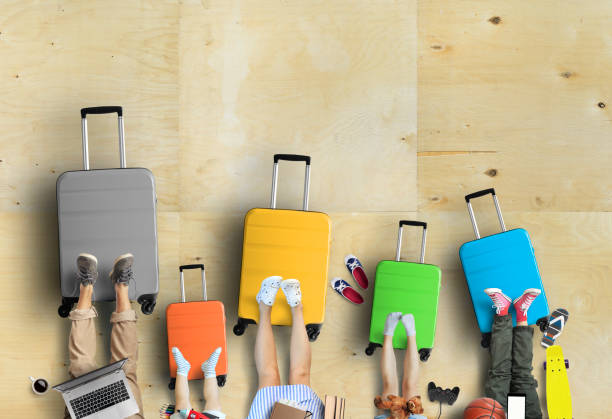 Family is going on a trip, five colored suitcases with clothes stock photo