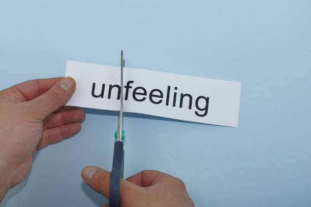 istock unfeeling and feeling.hand cutting paper with scissors 1136245125