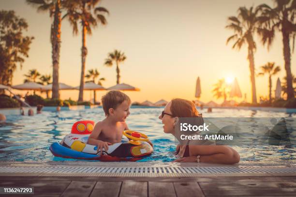Child With Mother In Swimming Pool Holiday Resort Stock Photo - Download Image Now - Family, Vacations, Swimming Pool