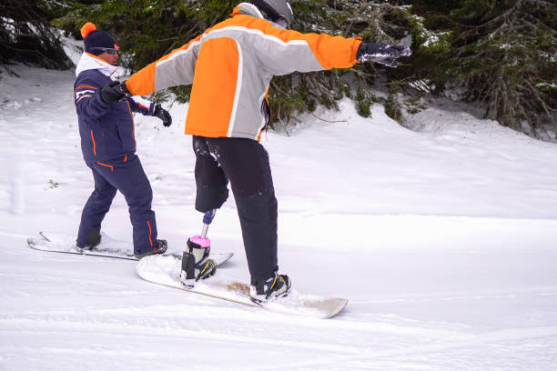 istock Amputee Snowboarder with Prosthetic Leg 1136248462