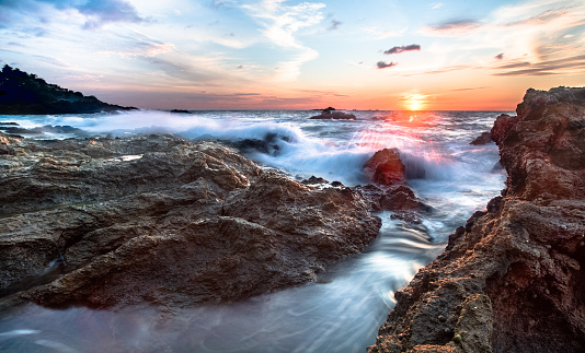 Long exposure at sunset of waves crashing on the west side of the Osa Peninsula, Costa Rica.